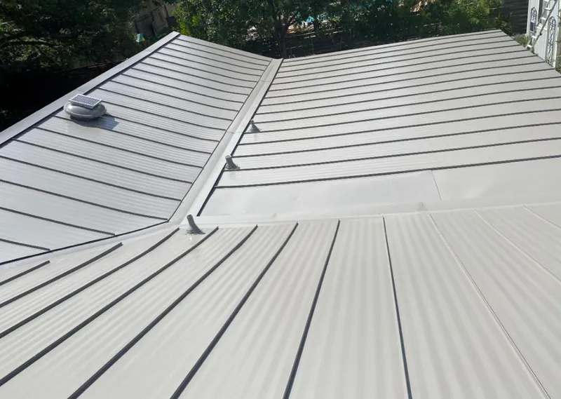 Solar attic fan installed on a metal roof for Roof Ventilation in Hutchinson